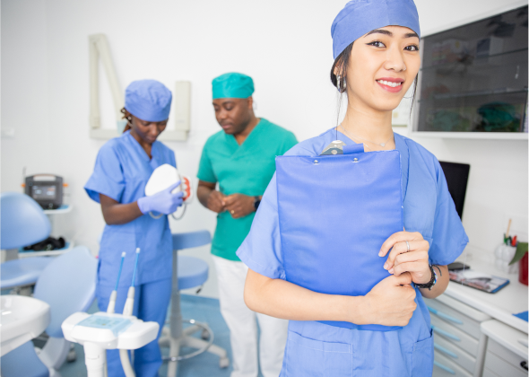 Doctors observe a model of the human mouth in a consultation room